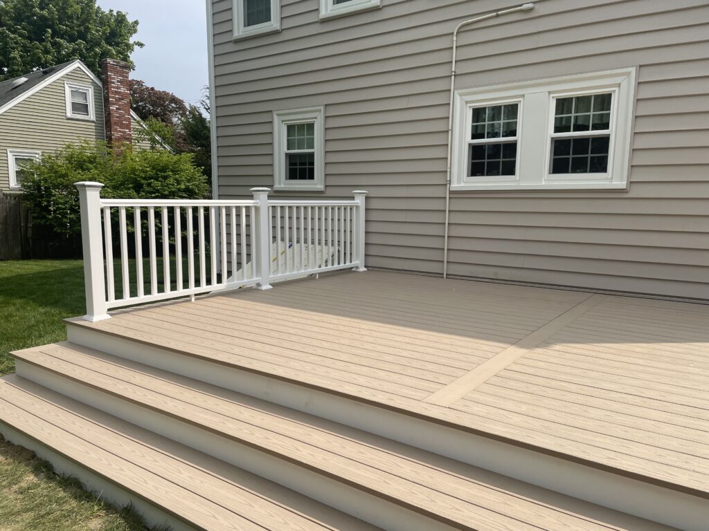 Professional Deck Builder in Brockton completing a spacious backyard deck